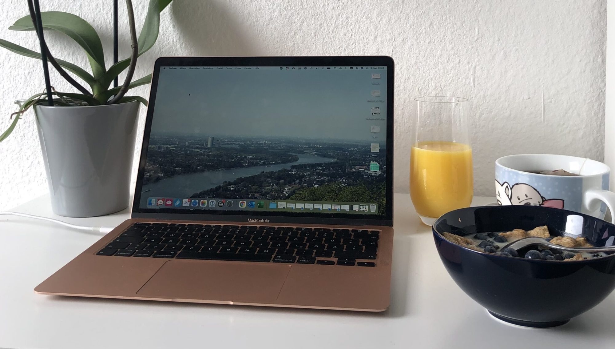 Laptop Orangensaft und Müslischale